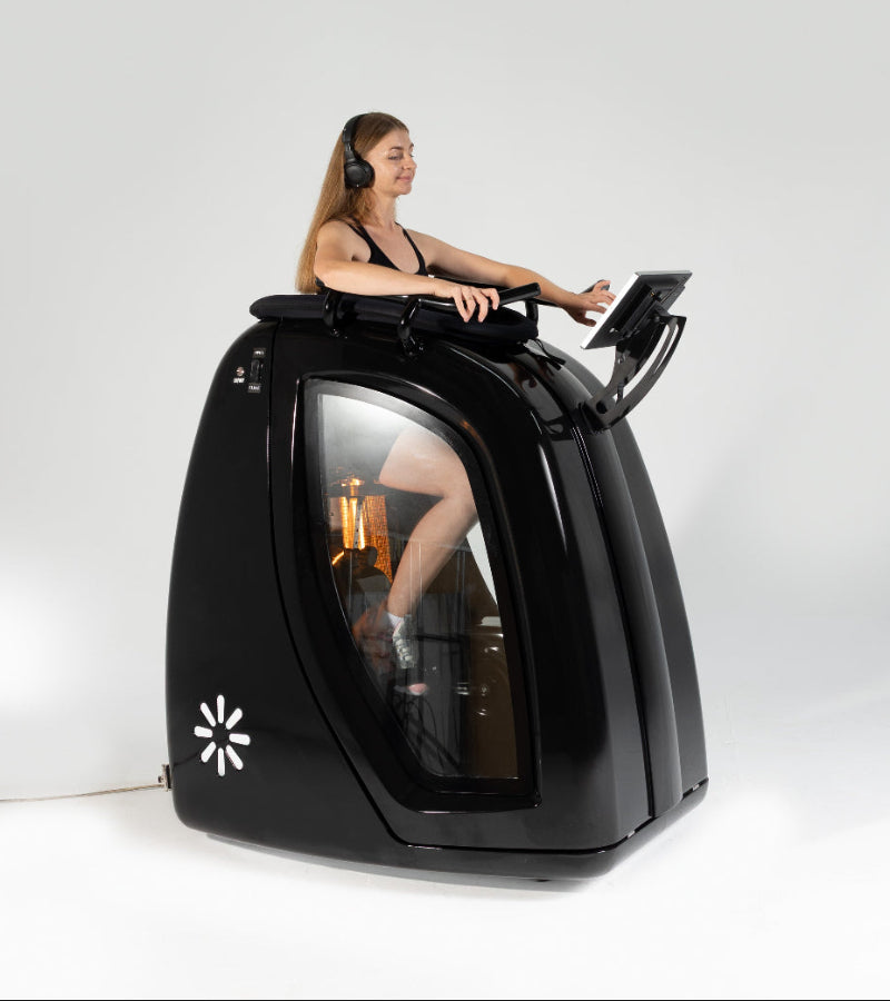 Person using a futuristic black pod with a screen and controls on a white background