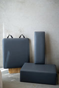 Load image into Gallery viewer, Three gray foam blocks with handles on a light gray background
